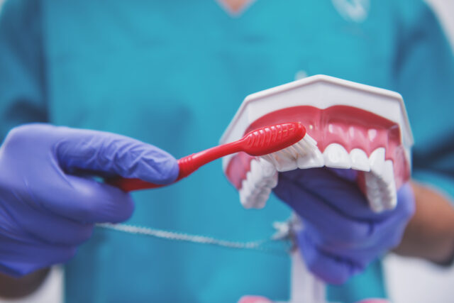 An image displaying healthy foods like fruits and vegetables next to a bright smile, illustrating how a balanced diet is one of the key oral hygiene tips.