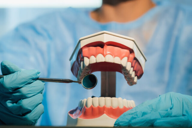 A friendly dentist providing a patient with professional advice in a modern clinic. Regular check-ups are vital for receiving personalized oral hygiene tips.