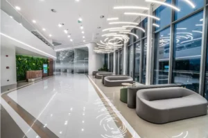 Futuristic white corridor and reception desk at the Esnan Skyland dental facility.